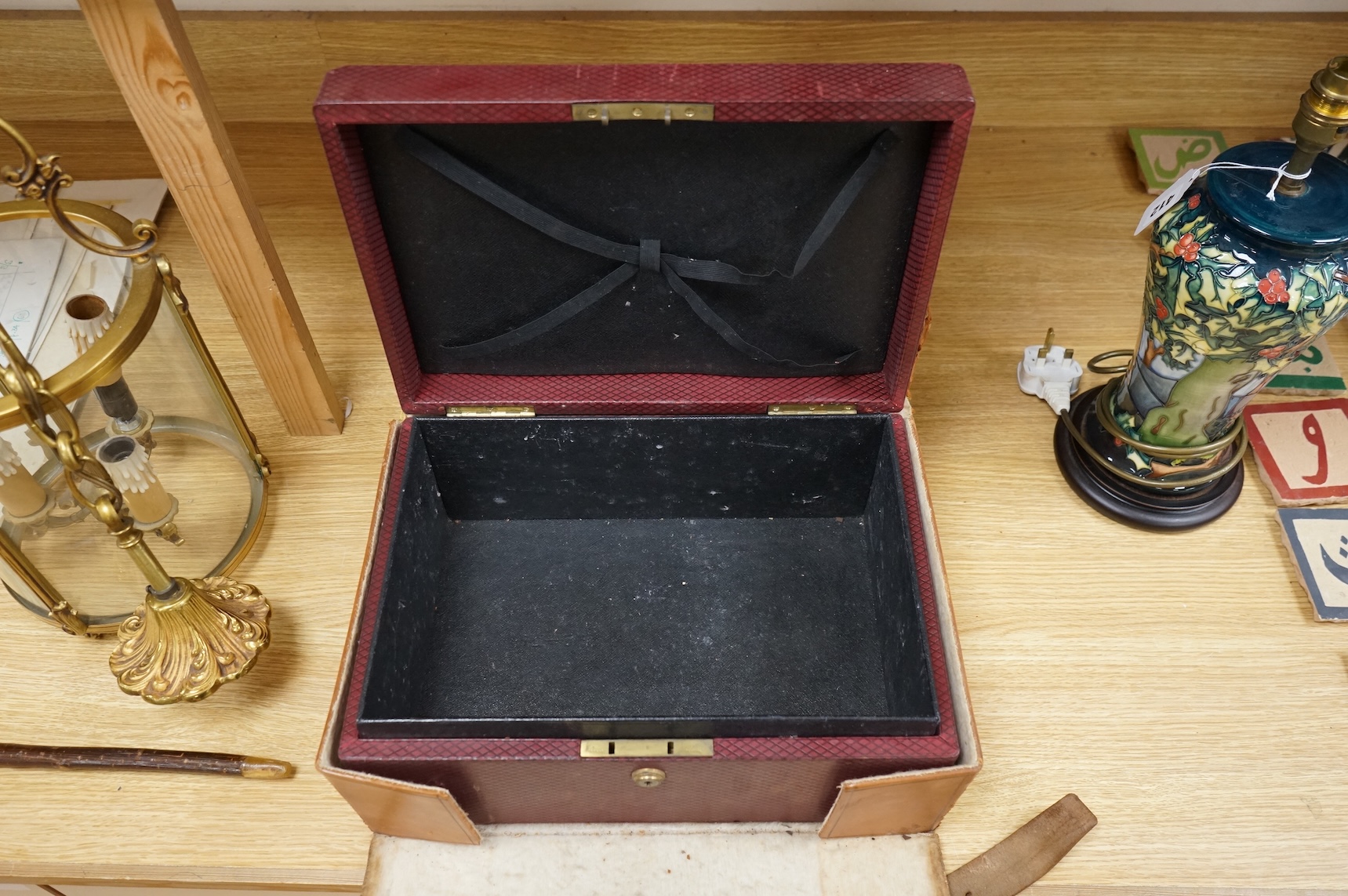 A cased travelling lock box with Bramah lock and leather case, no key, 36cm high